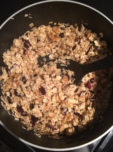 english flapjacks mixing oats walnuts dried cranberries with butter and honey mixture