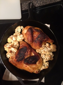 finished roasted chicken and cauliflower cast iron skillet
